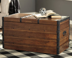 3 Brothers Decor - Ashley Furniture - Kettleby Storage Trunk - Storage Trunk / Brown - A4000096