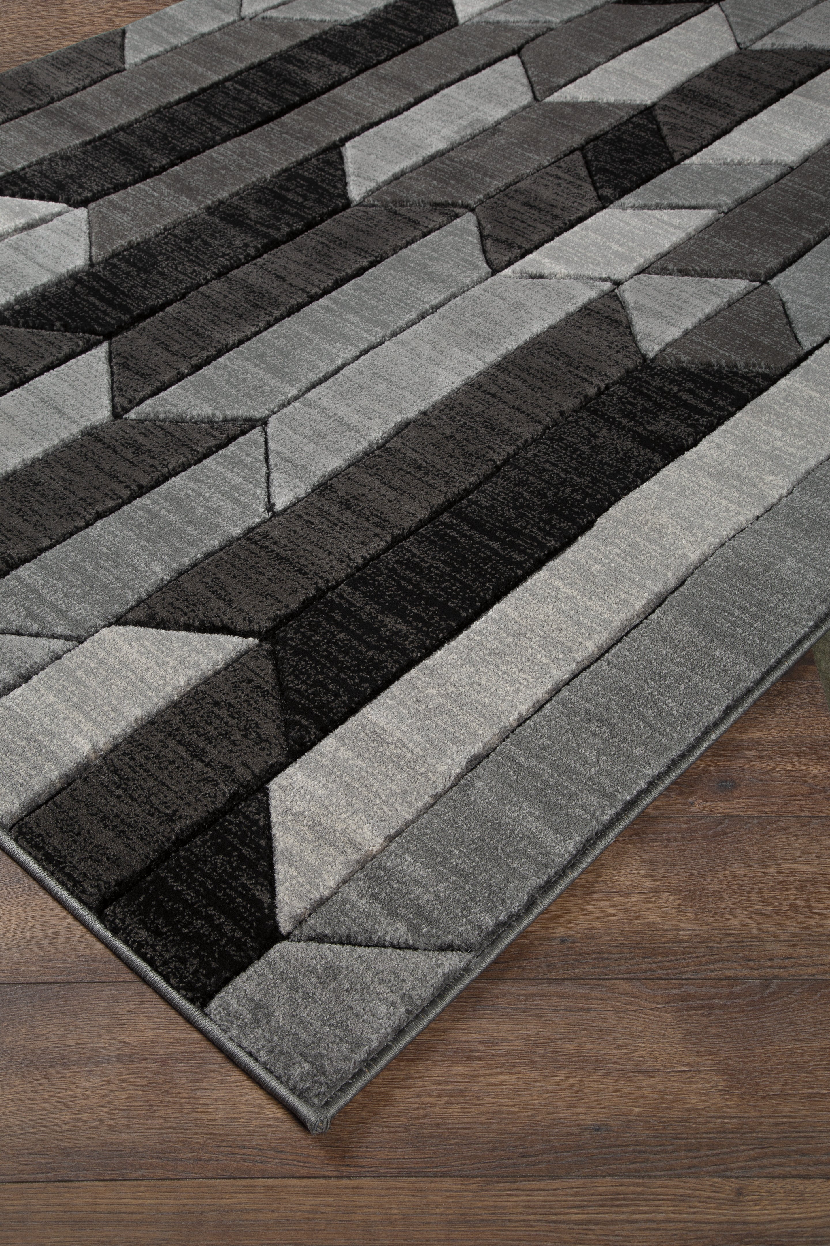 3 Brothers Decor - Ashley Furniture - Chayse Rug - 6'6" x 9'6" Rug / Black/Gray - R403461