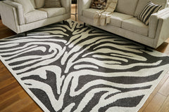 3 Brothers Decor - Ashley Furniture - Thomwith Rug - 8' x 10'2" Washable Rug / Black/Ivory - R406291