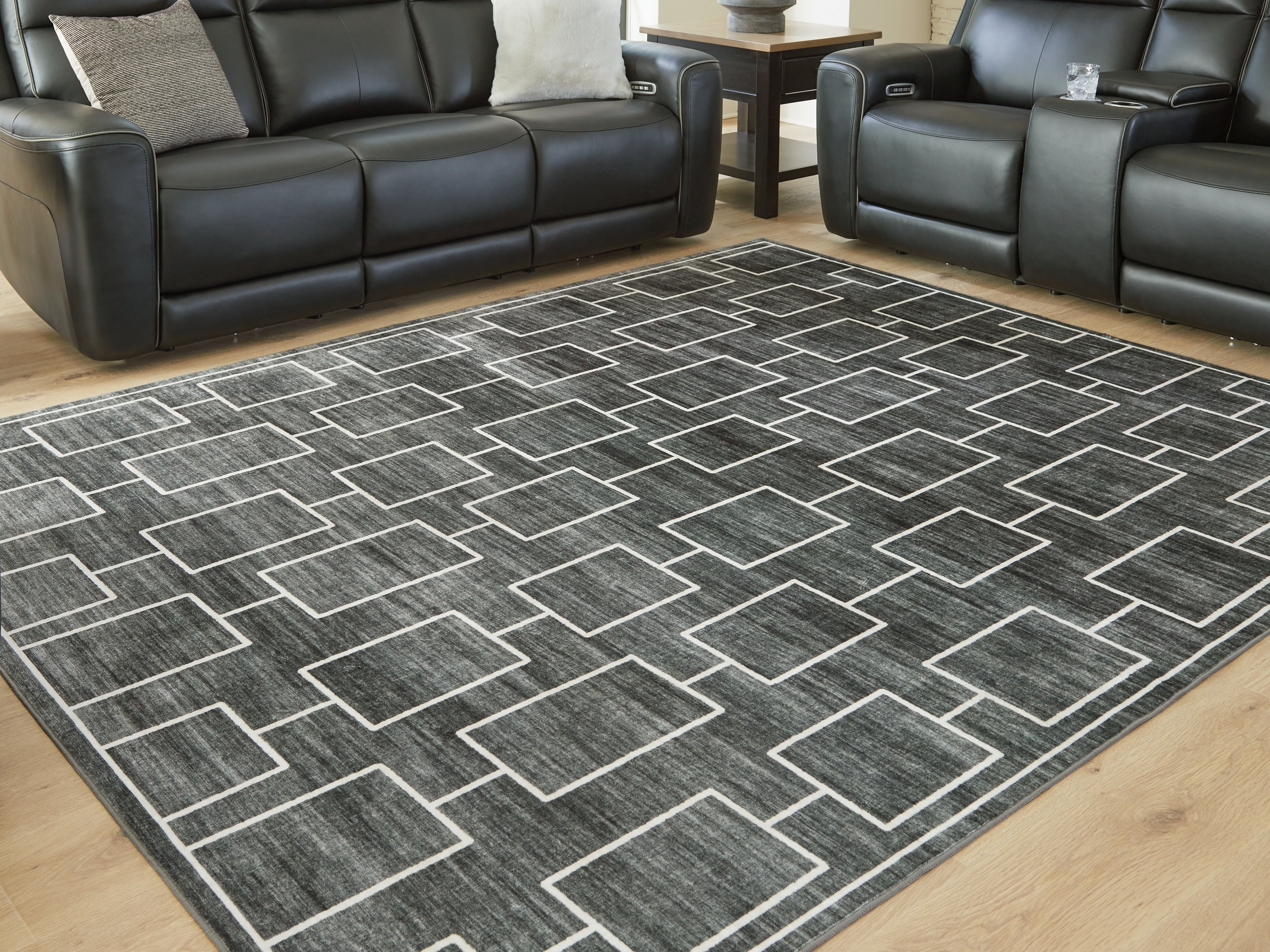 3 Brothers Decor - Ashley Furniture - Elderland Rug - Washable 7'6" x 9'6" Area Rug / Black/Gray - R407401