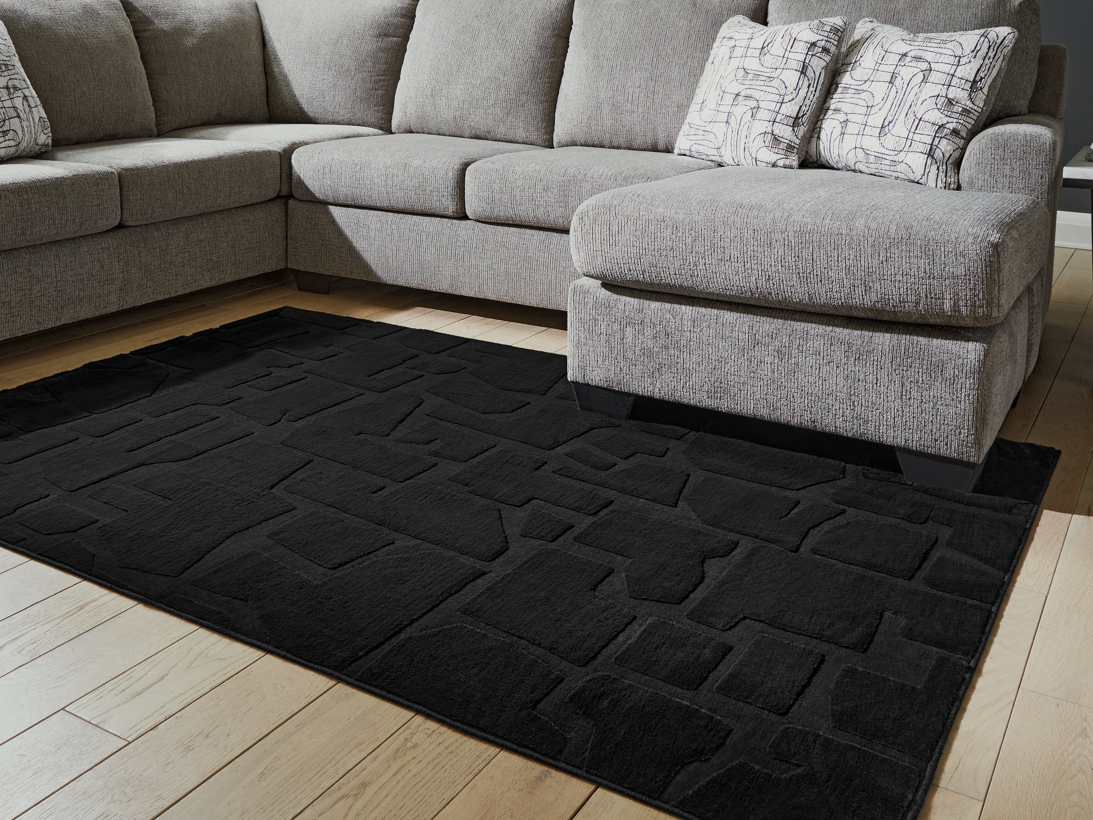 3 Brothers Decor - Ashley Furniture - Gibbswell Rug - Washable 5' x 7' Area Rug / Black - R407462