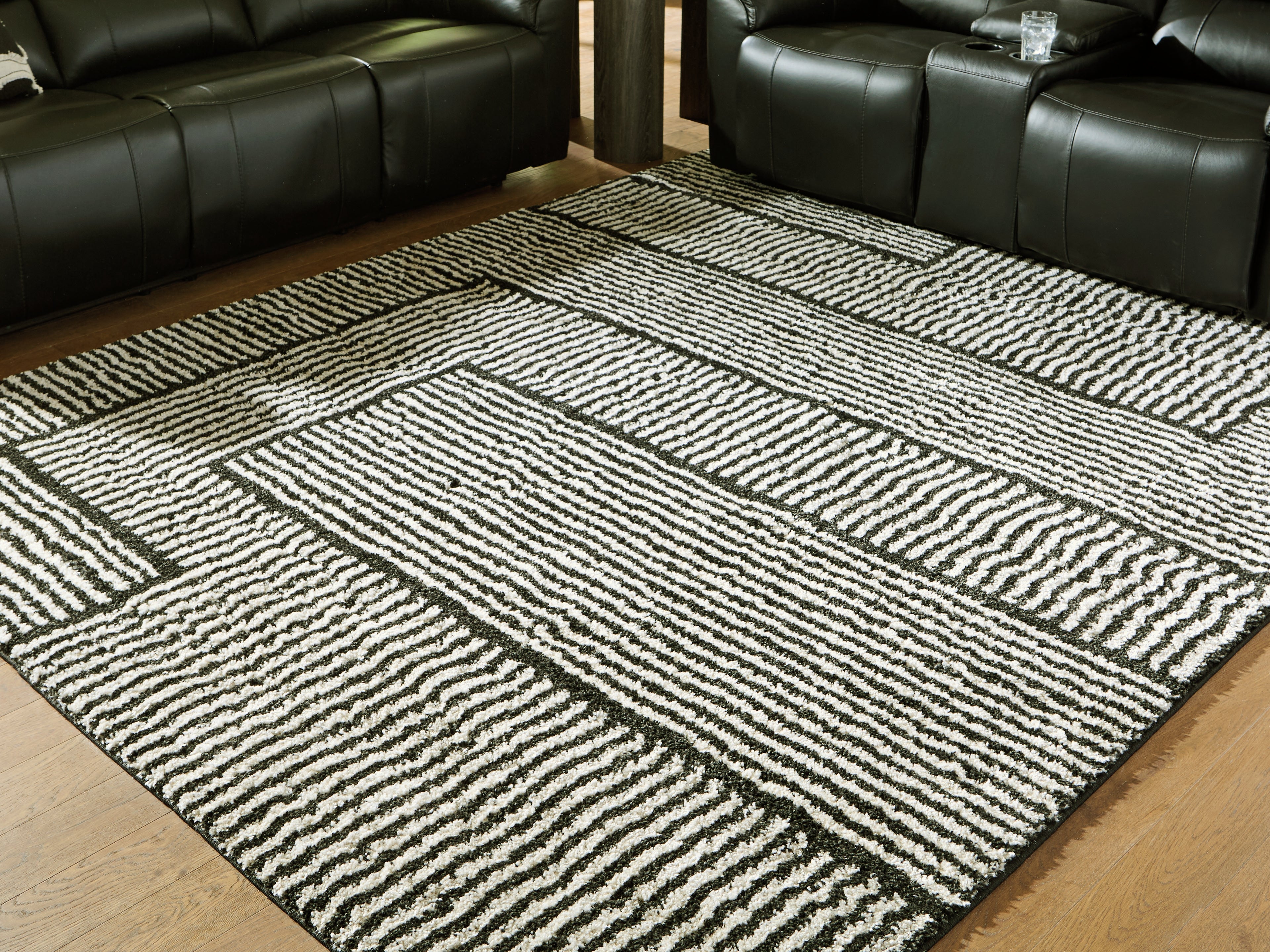 3 Brothers Decor - Ashley Furniture - Kurtmen Rug - 7'10" x 9'10" Area Rug / Black/Ivory - R407591