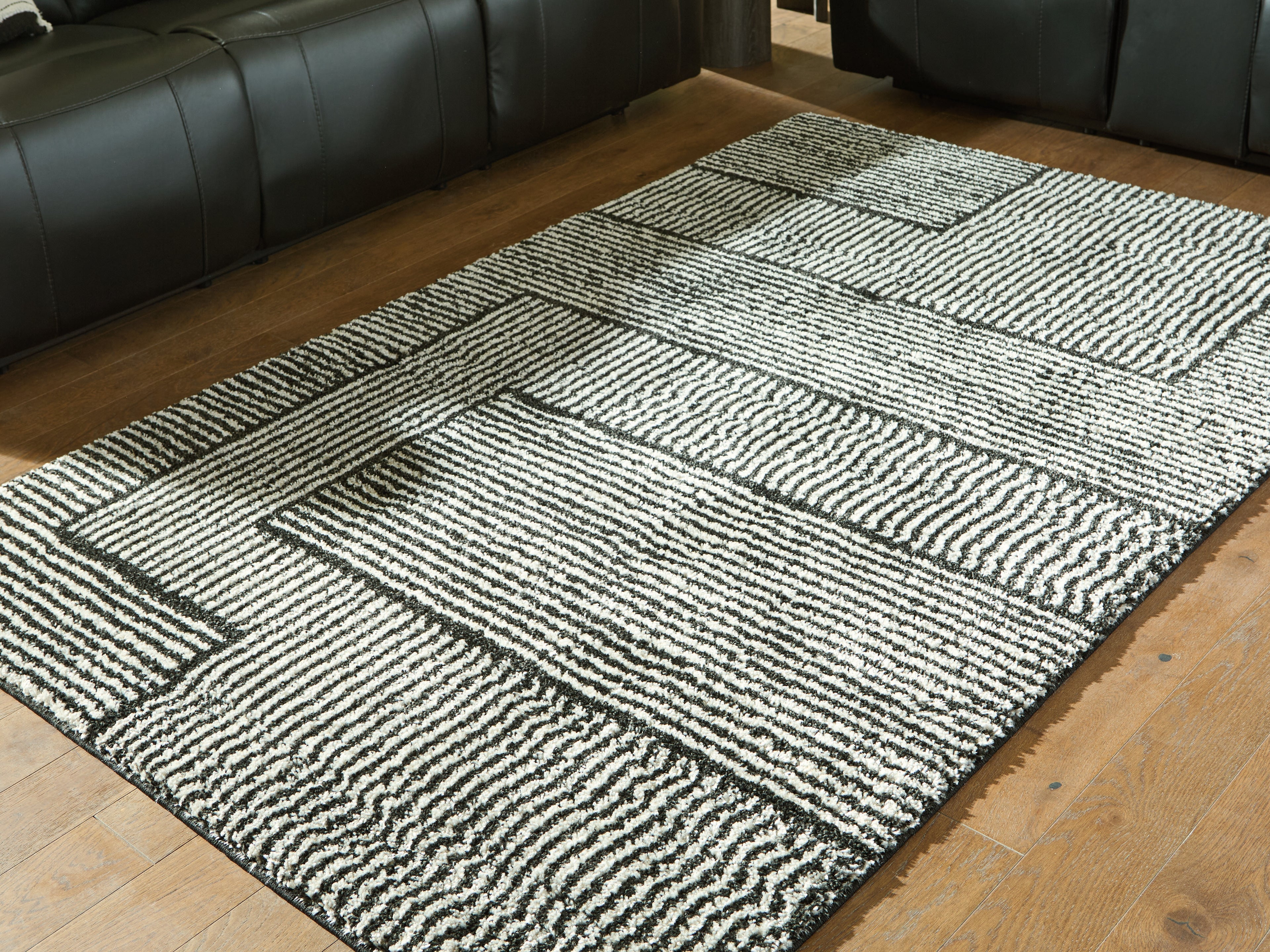 3 Brothers Decor - Ashley Furniture - Kurtmen Rug - 5' x 7' Area Rug / Black/Ivory - R407592